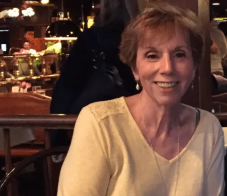 Patient advocate Bobbi Cohen smiling while seated at a restaurant
