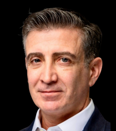Headshot of Dr. Drew Moghanaki with a dark background