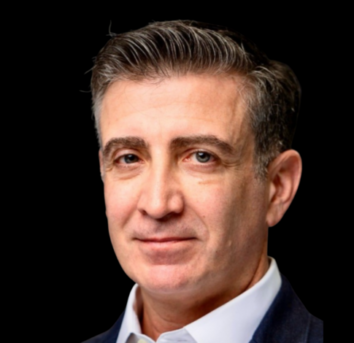 Headshot of Dr. Drew Moghanaki with a dark background