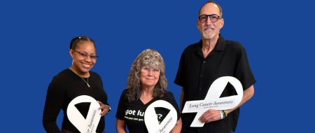 Jamie, Donnita, and Jeff displaying their white ribbons